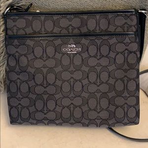 Black crossbody Coach bag with signature design